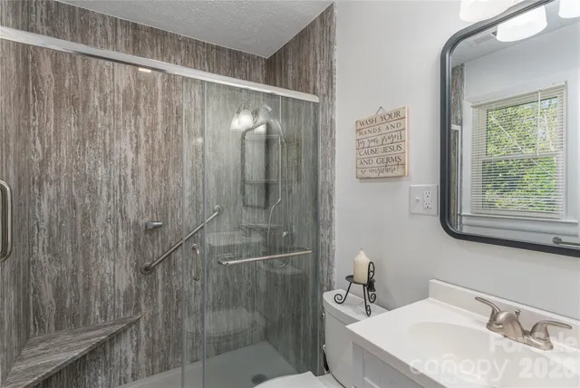 a bathroom with a shower and a sink