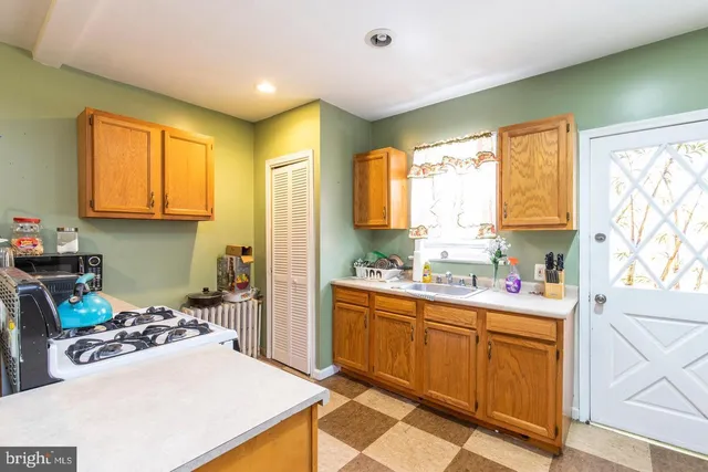 a kitchen with a sink stove and cabinets