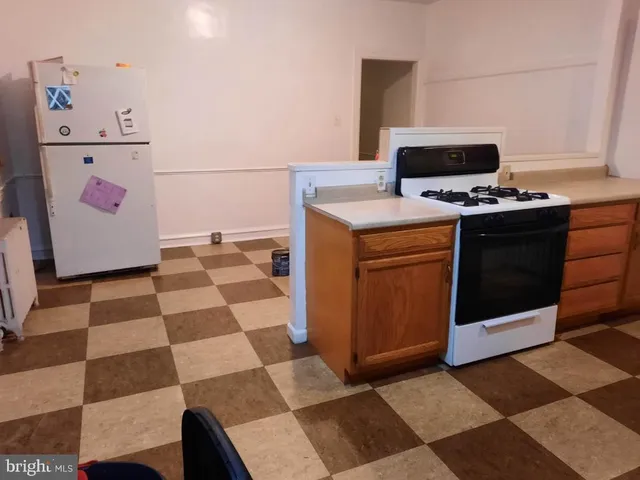 a kitchen with a stove a sink and a refrigerator