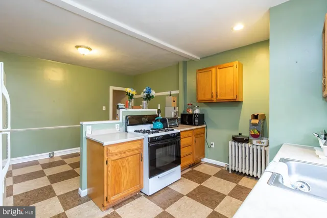 a kitchen that has a sink and a stove in it