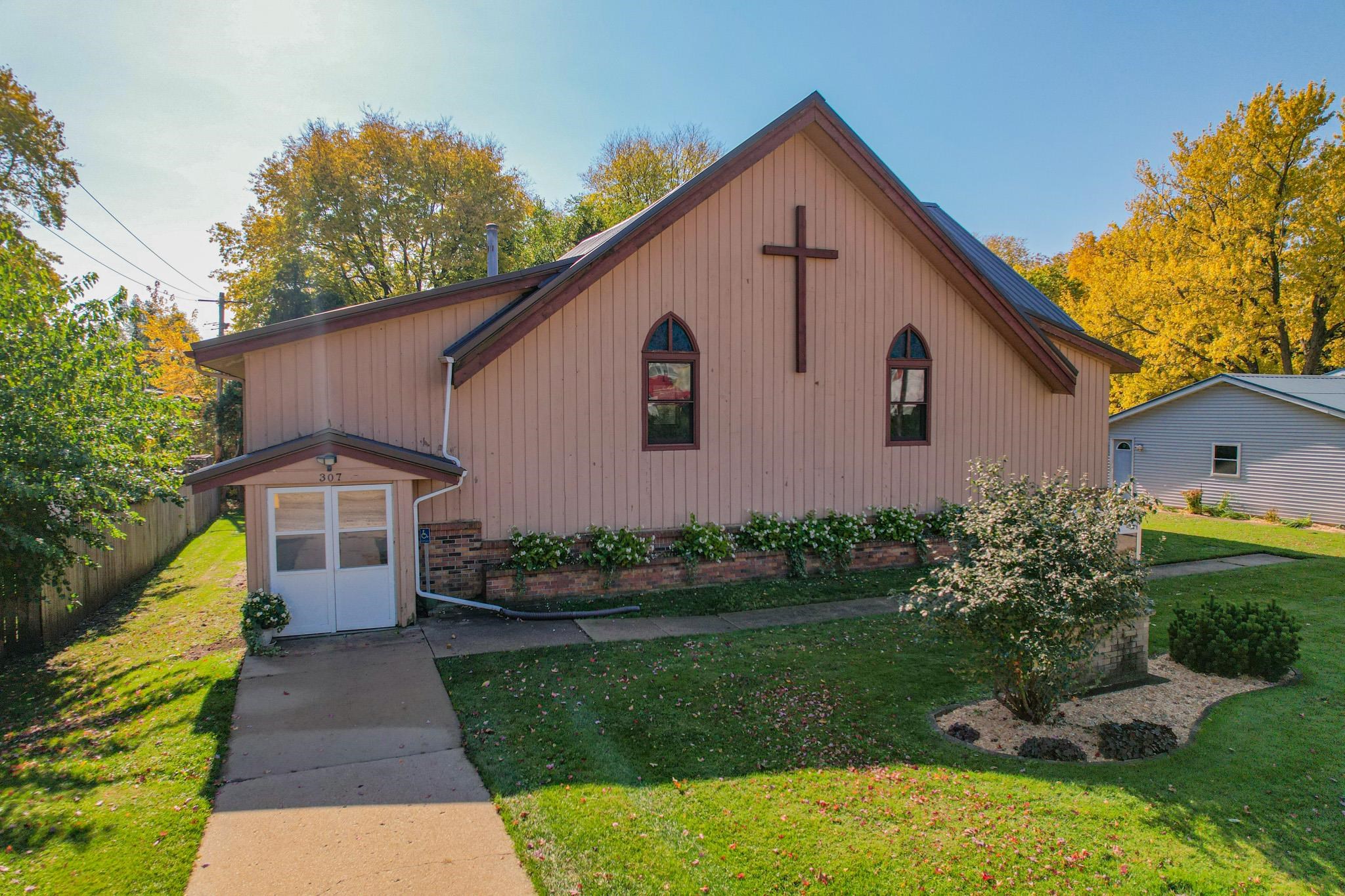 307 West Main Street Monroe Center, IL 61052 - Photo 2 of 31 a front view of a house with a yard and garage