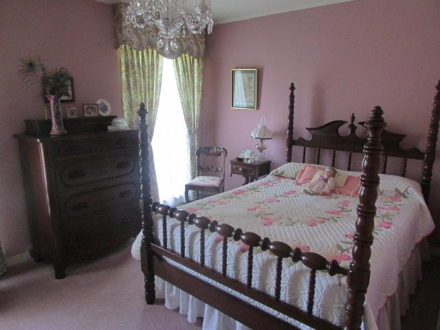 10 Barns Road Leoma, TN 38468 - Photo 9 of 19 a bedroom with a bed and a chandelier