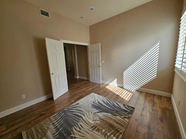 a spacious bathroom with a granite countertop sink a mirror and a bathtub