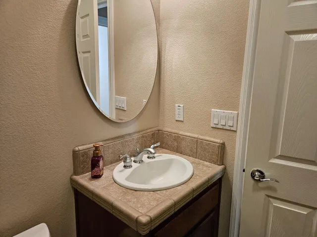 a large kitchen with stainless steel appliances granite countertop a stove refrigerator and a wooden cabinets