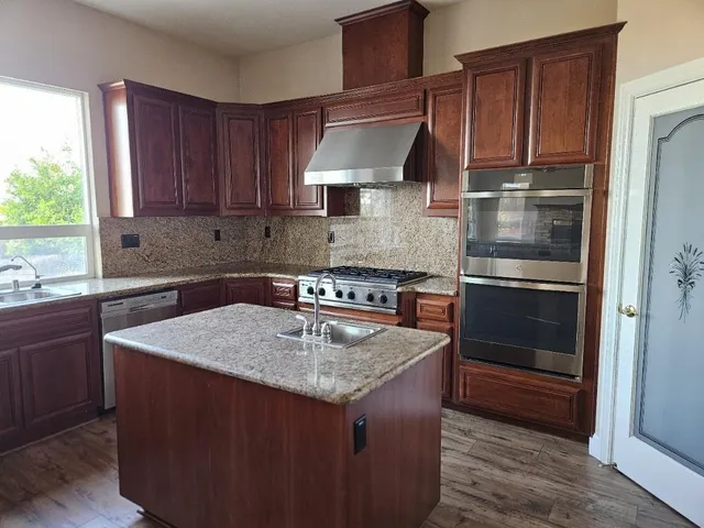 a large bathroom with a tub sink and mirror