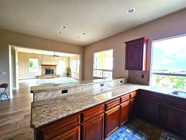 a bathroom with a granite countertop sink and a bathtub