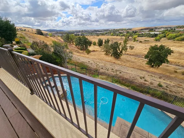 a view of a hallway with wooden shelves
