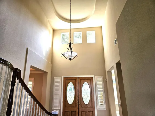 a view of a chandelier fan and wooden floor