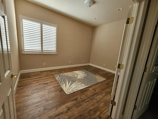 a kitchen with granite countertop a stove cabinets and refrigerator