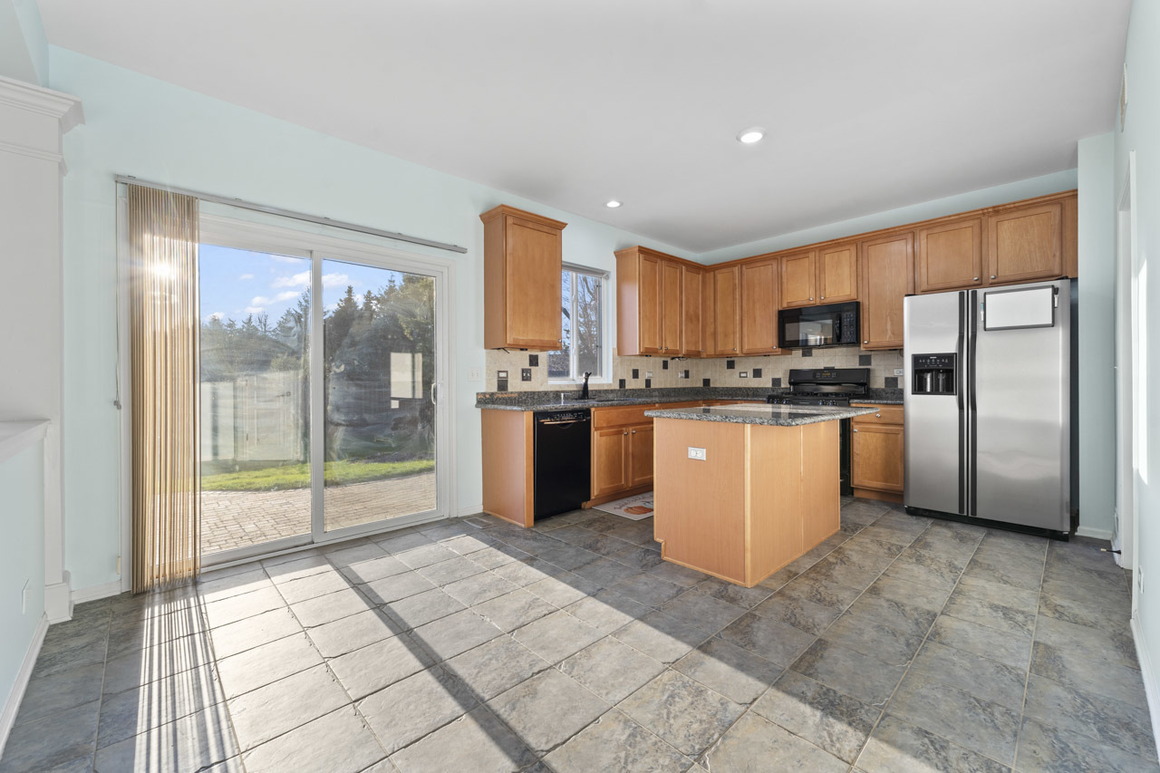 149 Lilac Street Bolingbrook, IL 60490 - Photo 12 of 50 a kitchen with stainless steel appliances a refrigerator a sink a stove top oven and cabinets