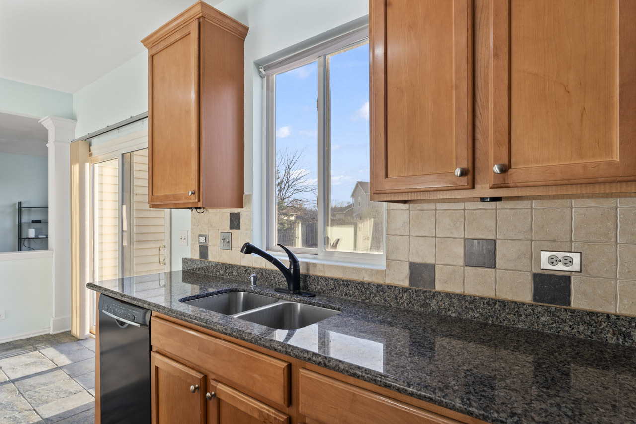 149 Lilac Street Bolingbrook, IL 60490 - Photo 16 of 50 a kitchen with stainless steel appliances granite countertop a sink a counter and a cabinets