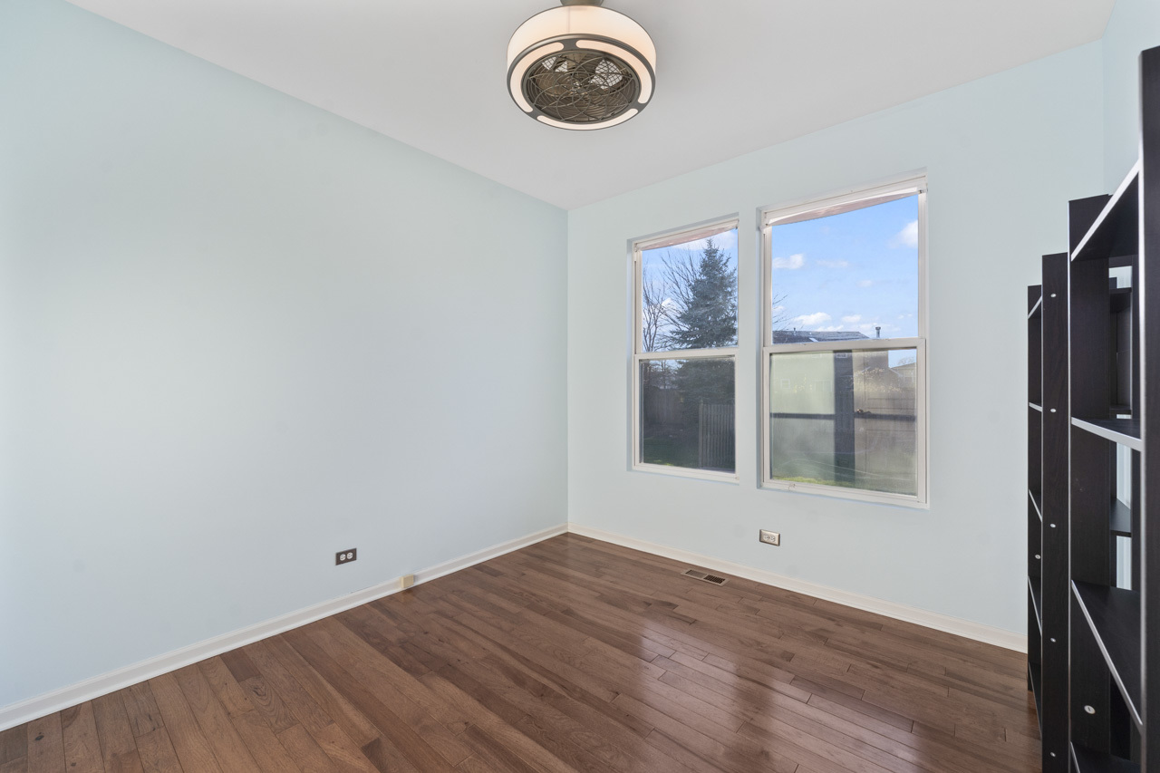149 Lilac Street Bolingbrook, IL 60490 - Photo 17 of 50 a view of an empty room with wooden floor and a window