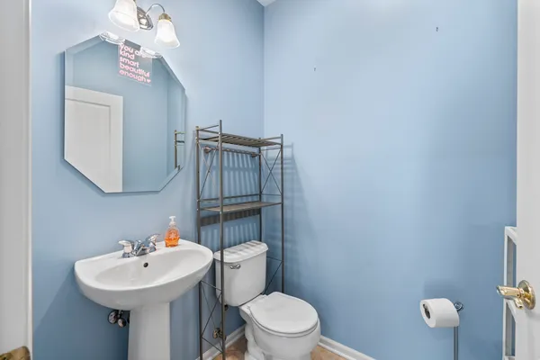 a bathroom with a sink a toilet and mirror