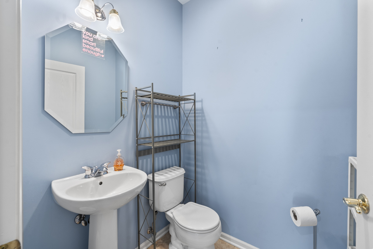 149 Lilac Street Bolingbrook, IL 60490 - Photo 19 of 50 a bathroom with a sink a toilet and mirror