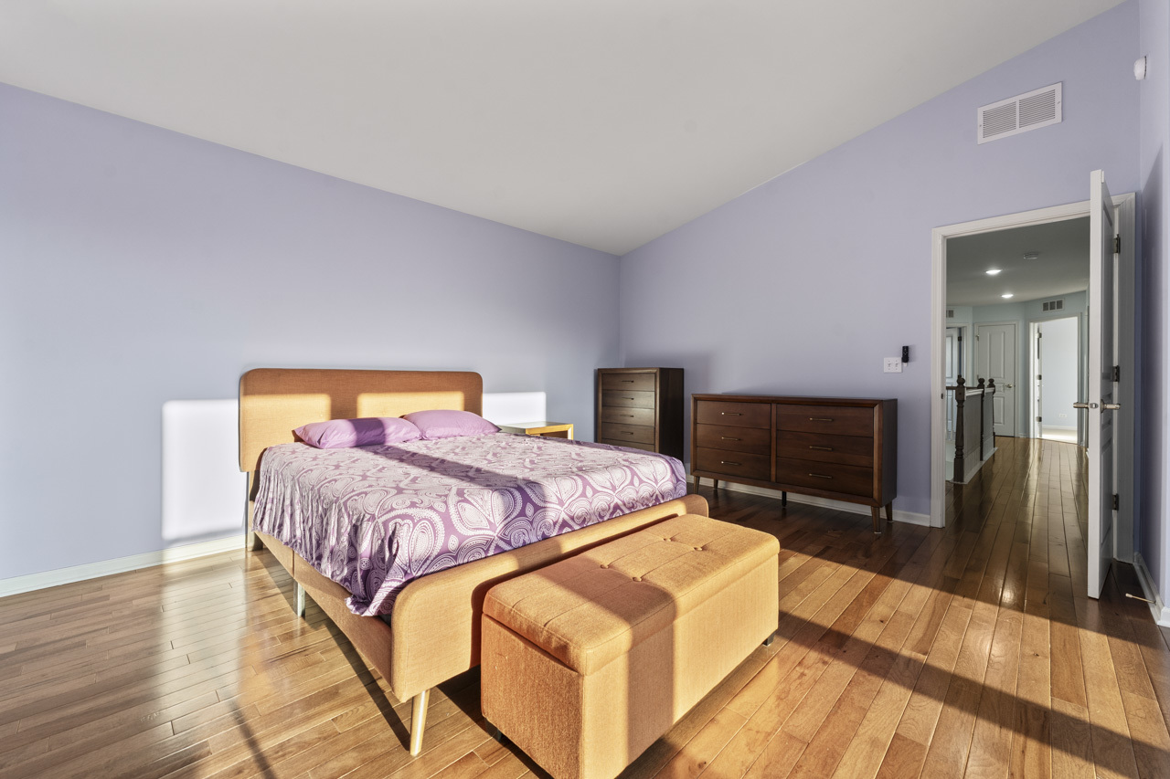 149 Lilac Street Bolingbrook, IL 60490 - Photo 22 of 50 a bedroom with a bed and wooden floor