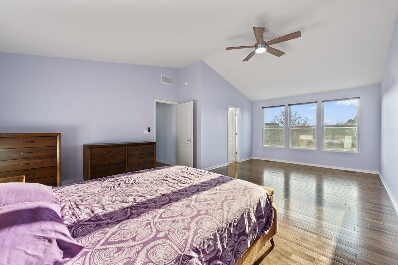 149 Lilac Street Bolingbrook, IL 60490 - Photo 23 of 50 a bedroom with a large bed and a chandelier