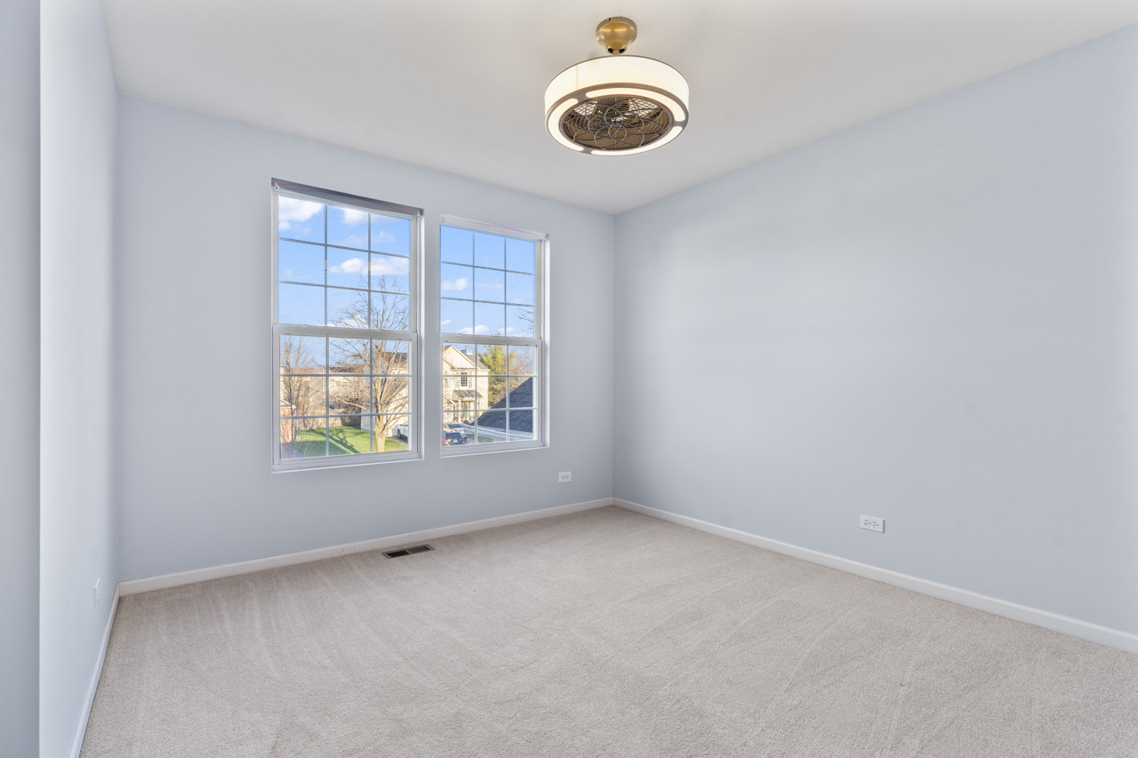 149 Lilac Street Bolingbrook, IL 60490 - Photo 27 of 50 an empty room with windows and ceiling fan