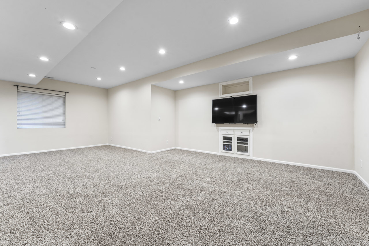 149 Lilac Street Bolingbrook, IL 60490 - Photo 35 of 50 an empty room with a flat screen tv and painted walls