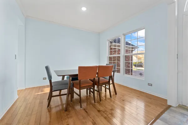 a view of a dining room with furniture and wooden floor