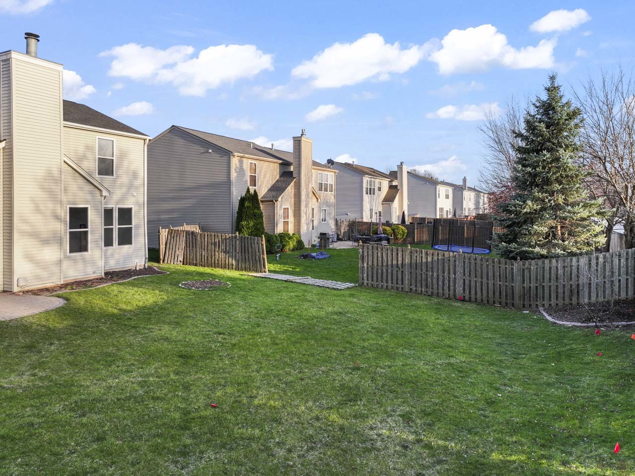 149 Lilac Street Bolingbrook, IL 60490 - Photo 44 of 50 a view of a garden with a small yard and wooden fence