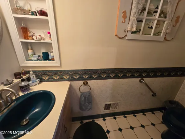 a bedroom with furniture and a mirror