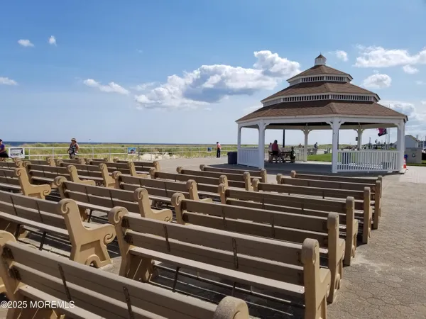 a view of a patio with chairs next to a yard