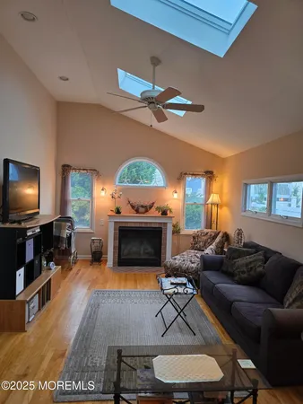 a living room with furniture a fireplace and a flat screen tv
