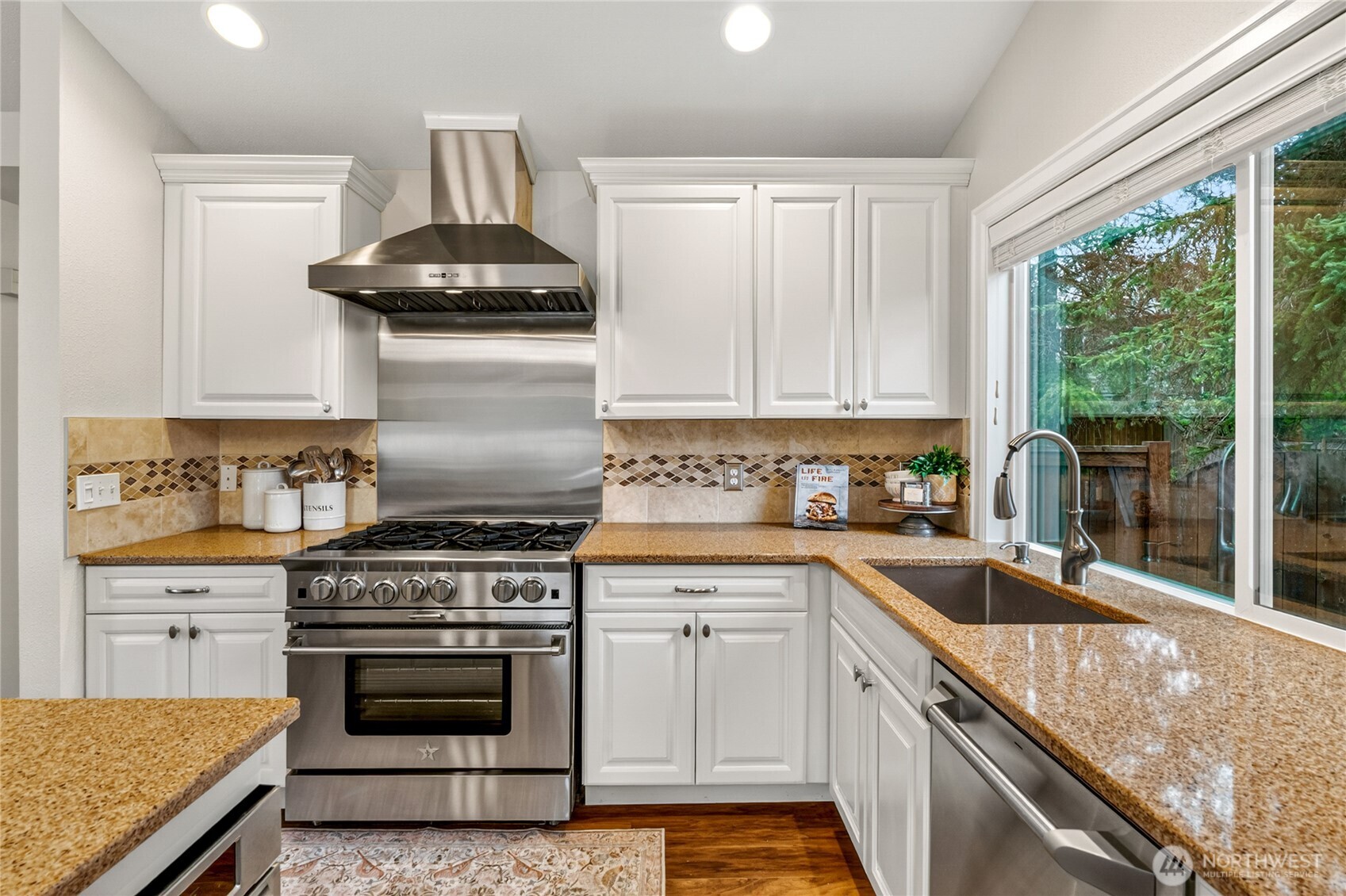 13236 Southeast 161st Place Renton, WA 98058 - Photo 15 of 38 a kitchen with granite countertop a sink stainless steel appliances and cabinets