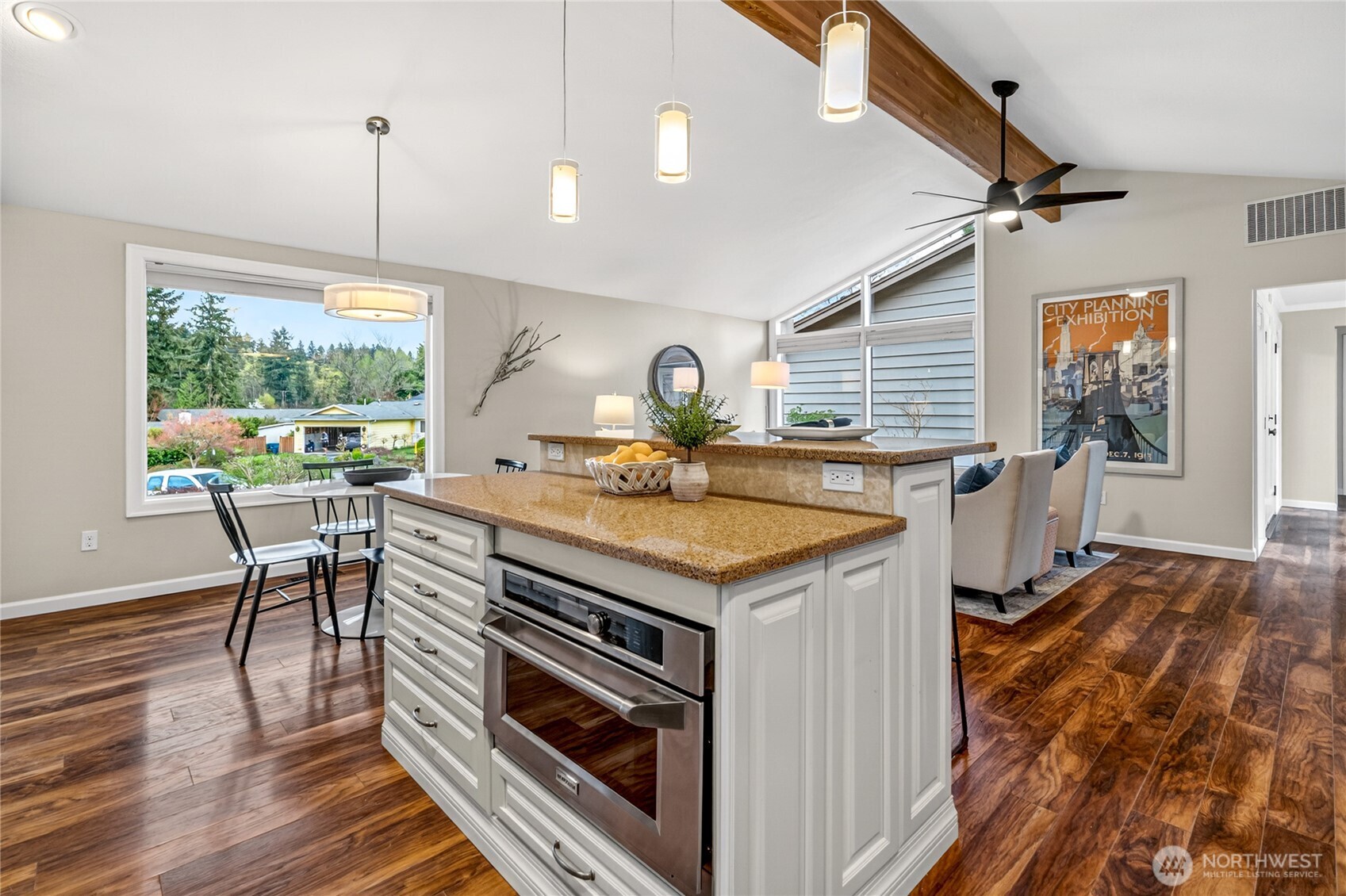 13236 Southeast 161st Place Renton, WA 98058 - Photo 18 of 38 a kitchen with a stove a sink a dining table and chairs with wooden floor