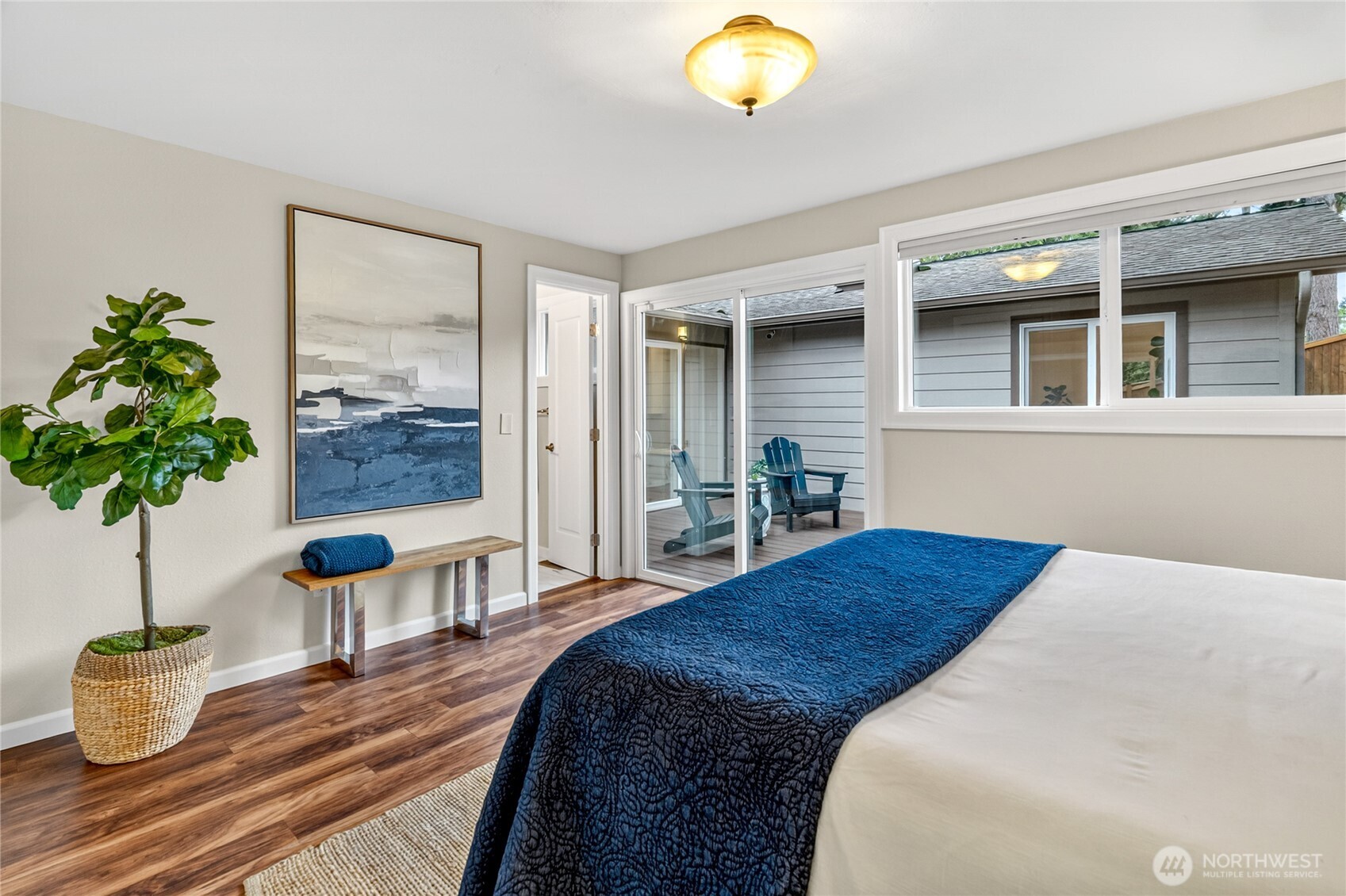 13236 Southeast 161st Place Renton, WA 98058 - Photo 21 of 38 a bedroom with a large bed and a potted plant