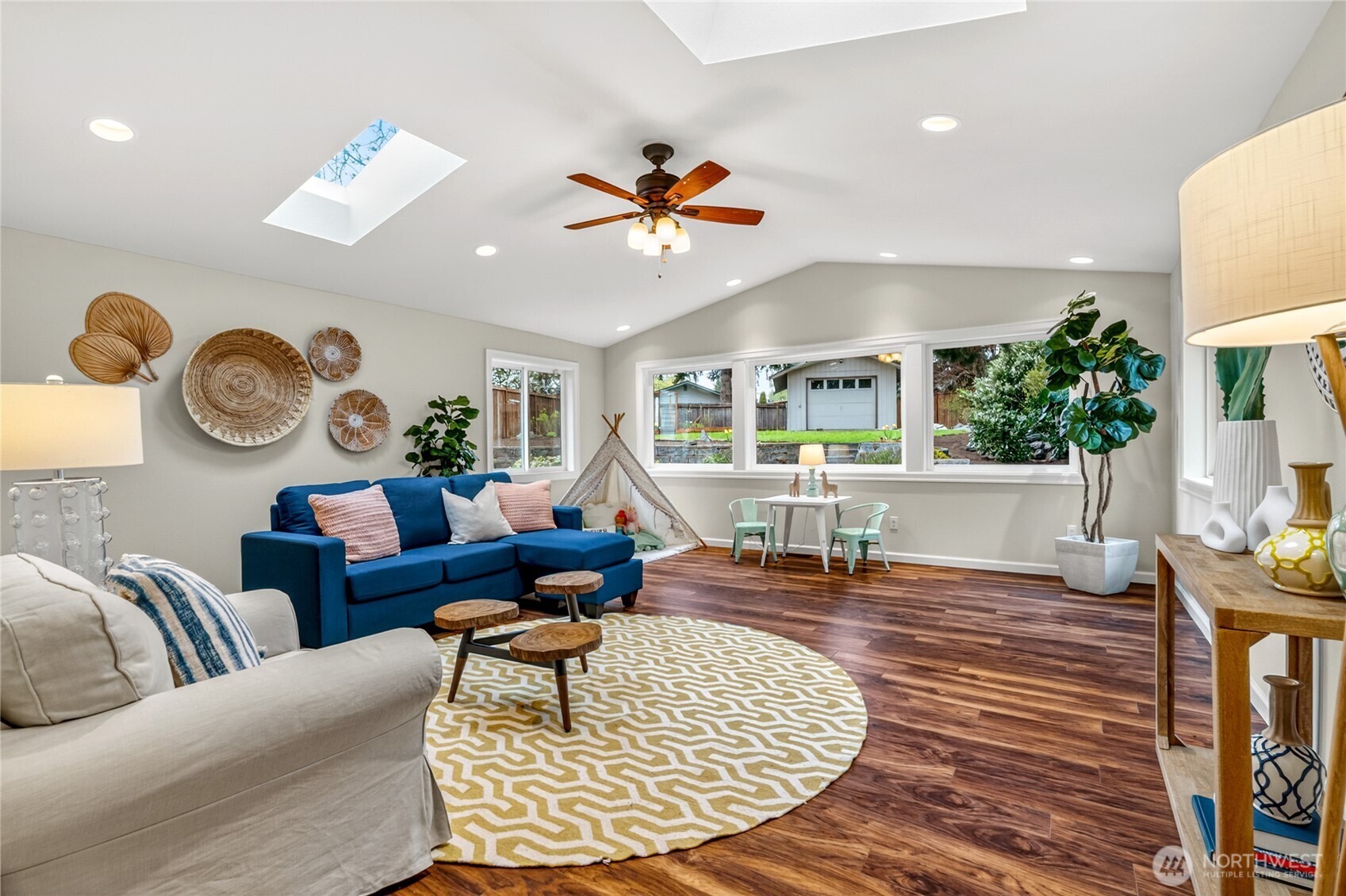 13236 Southeast 161st Place Renton, WA 98058 - Photo 27 of 38 a living room with couches a coffee table and a fireplace with wooden floor