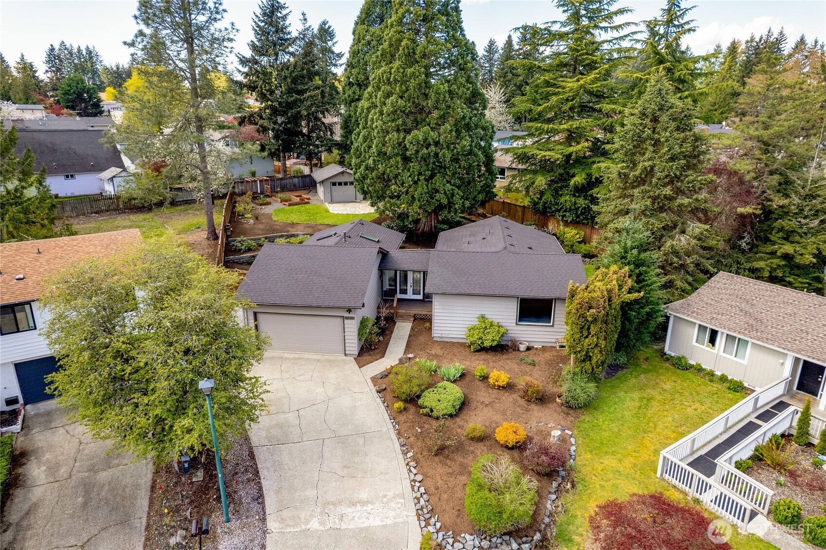 13236 Southeast 161st Place Renton, WA 98058 - Photo 3 of 38 an aerial view of a house with swimming pool and large trees