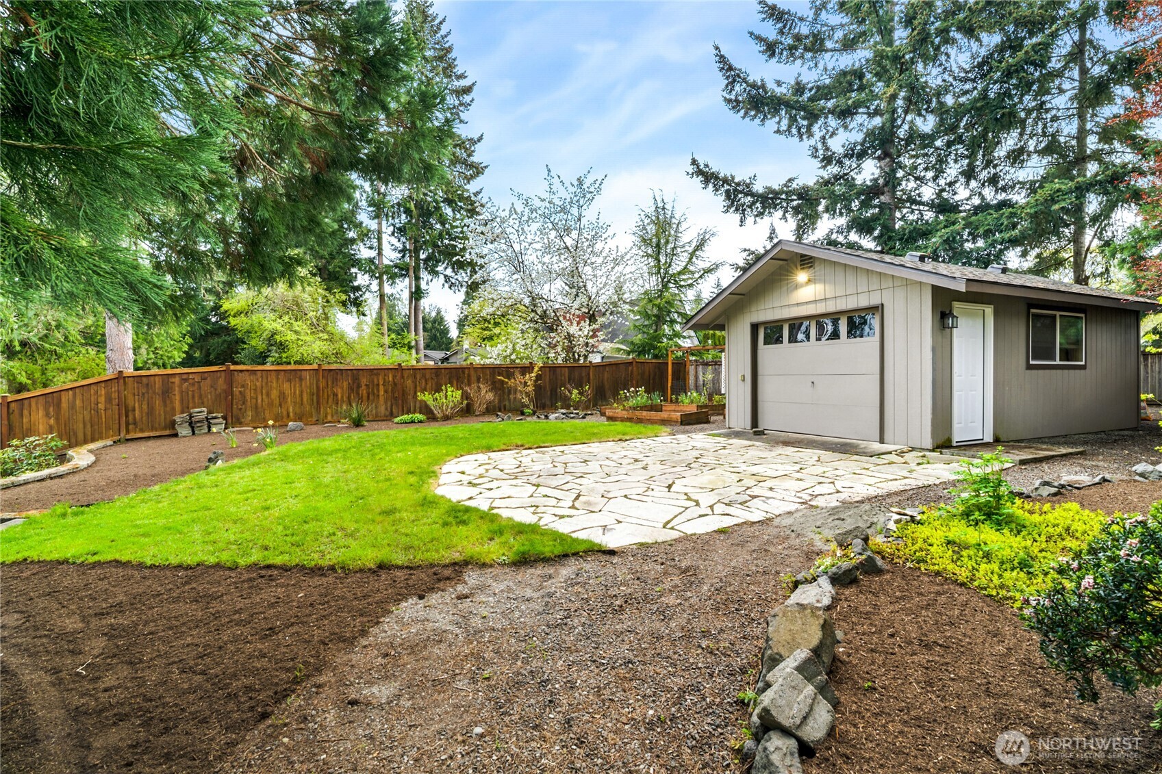 13236 Southeast 161st Place Renton, WA 98058 - Photo 31 of 38 a front view of a house with a garden and trees
