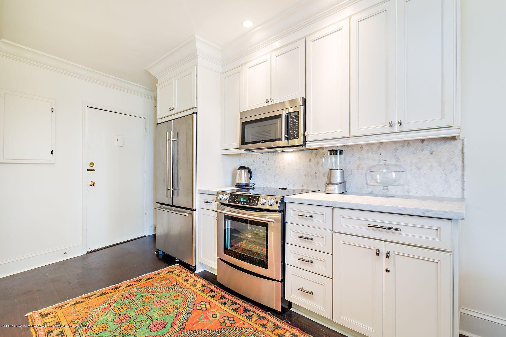 44 Cocoanut Row, Unit 326B Palm Beach, FL 33480 - Photo 5 of 19 a kitchen with stainless steel appliances granite countertop a stove a sink and a refrigerator