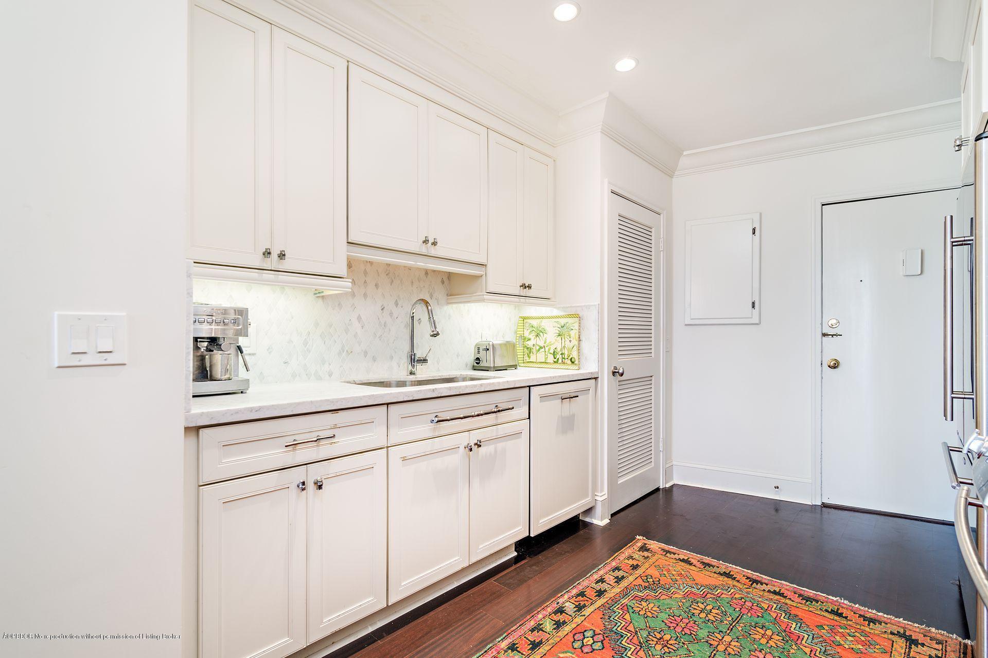 44 Cocoanut Row, Unit 326B Palm Beach, FL 33480 - Photo 6 of 19 a kitchen with white cabinets and sink