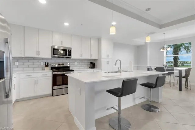 a kitchen with counter top space cabinets and stainless steel appliances