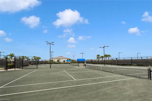 a swimming pool with outdoor seating and yard in the back