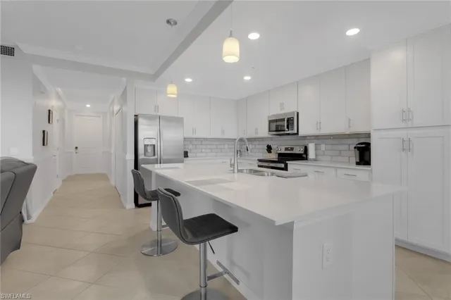 a kitchen with a refrigerator and a stove top oven