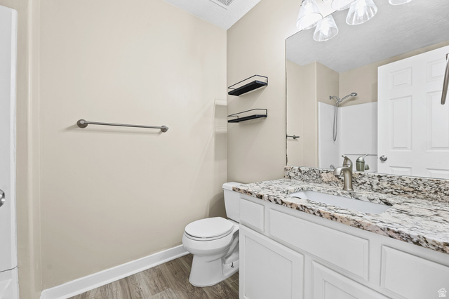 5525 Hampton Way Stansbury Park, UT 84074 - Photo 9 of 35 Bathroom featuring a vanity with a light-toned countertop, integrated sink, and brushed nickel faucet