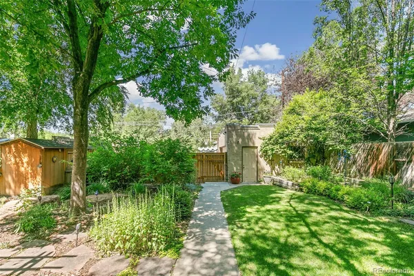 a house with lots of trees in the background