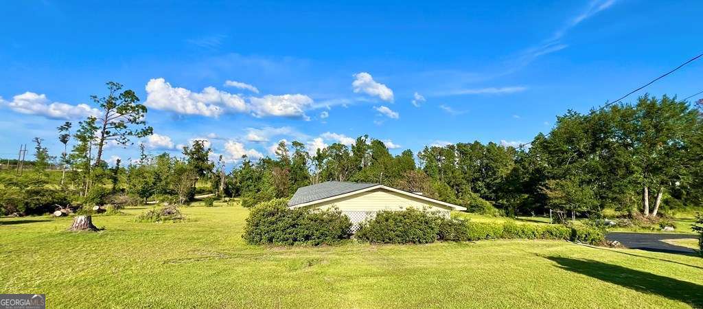 82 Cook Road Hazlehurst, GA 31539 - Photo 13 of 57 a view of a swimming pool with an outdoor space and seating area