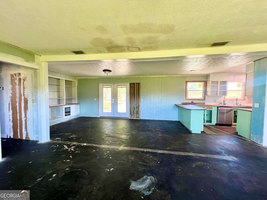 82 Cook Road Hazlehurst, GA 31539 - Photo 32 of 57 wooden view of an empty room with a fireplace and a window