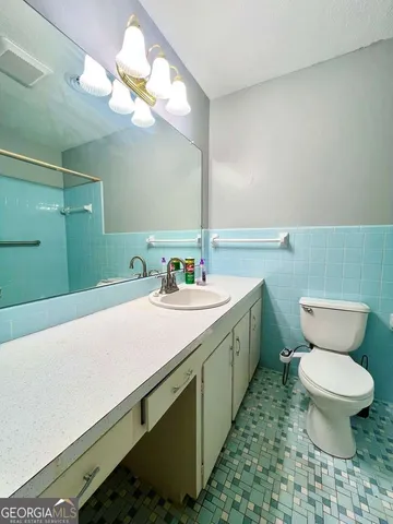 a spacious bedroom with a bed and a window