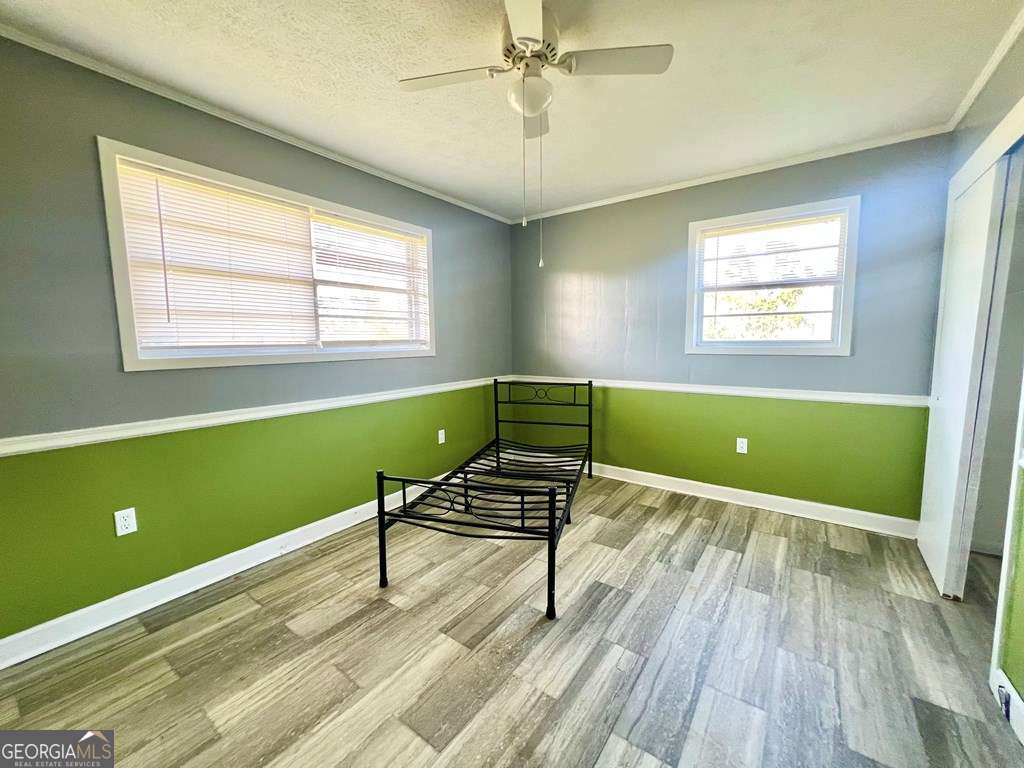 82 Cook Road Hazlehurst, GA 31539 - Photo 39 of 57 a view of an empty room with a window and wooden floor