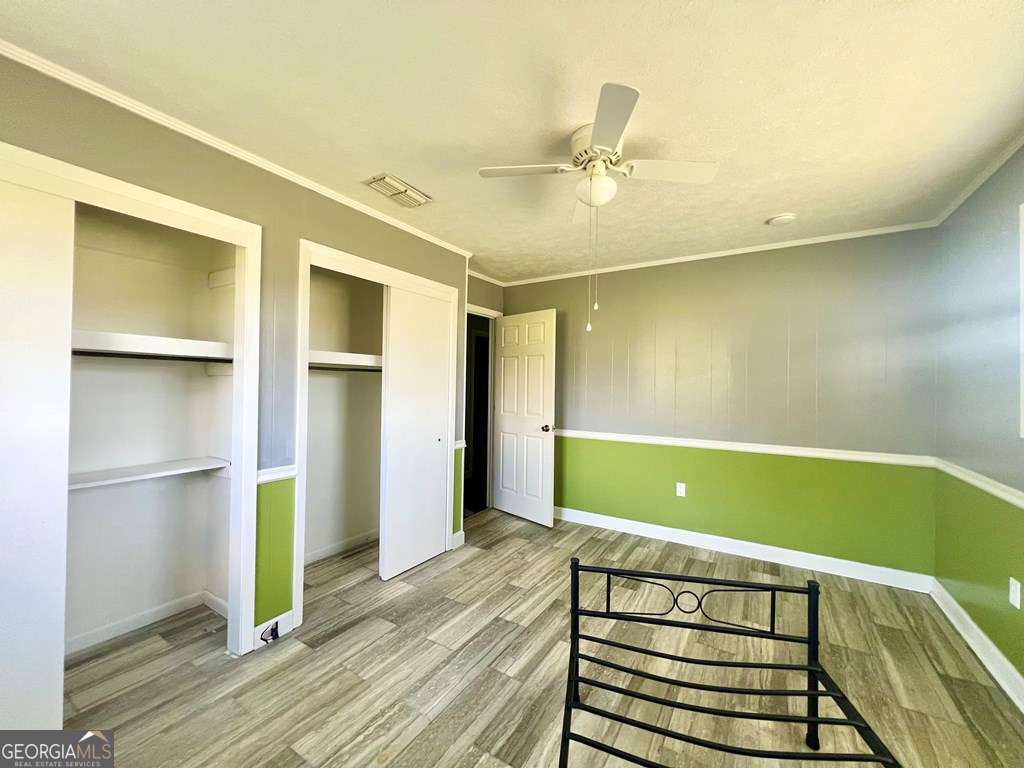 82 Cook Road Hazlehurst, GA 31539 - Photo 40 of 57 a view of a room with wooden floor and staircase