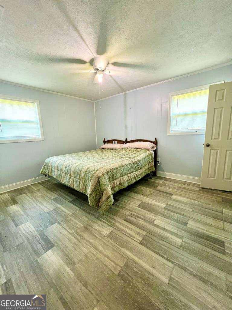 82 Cook Road Hazlehurst, GA 31539 - Photo 41 of 57 a spacious bedroom with a bed and a window