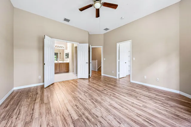 a view of an empty room with wooden floor