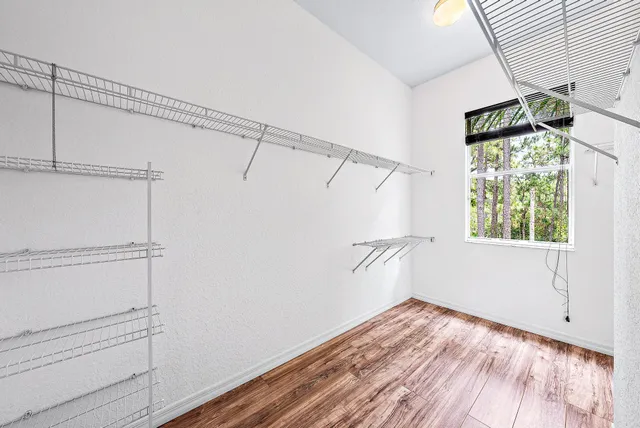 a view of a room with wooden floor and white walls