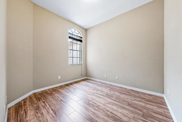 wooden floor in an empty room with a window