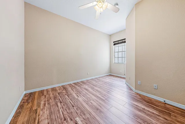 wooden floor in an empty room with a window